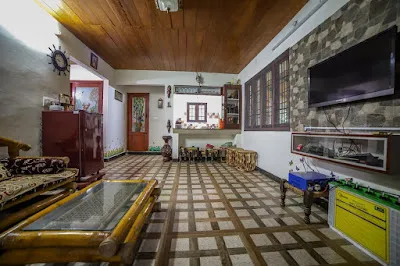 The Stone Villa hall looking through to the kitchen, with a patterned tiled floor and wooden ceiling
